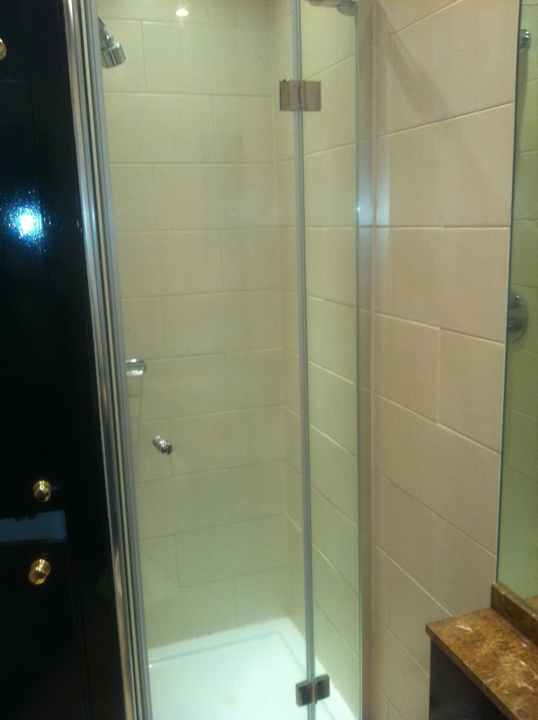 Frameless glass shower enclosure with chrome fittings in Waltham Abbey